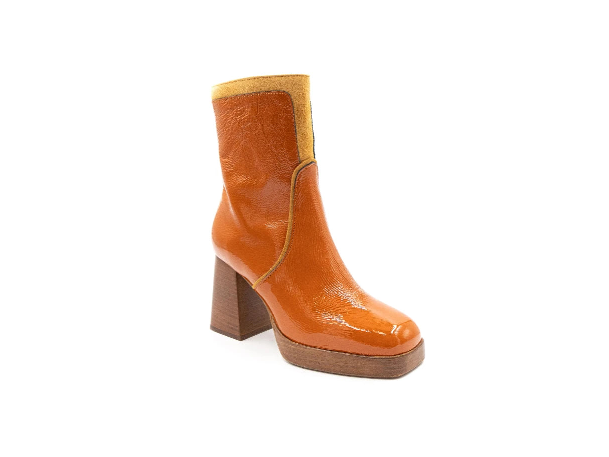 Orange ankle boot with a block heel on a white background