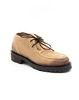 Tan suede shoe with black laces on a white background