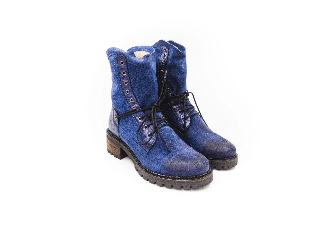 Pair of blue suede boots with black laces on a white background