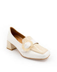 White shoe with a decorative strap on a white background