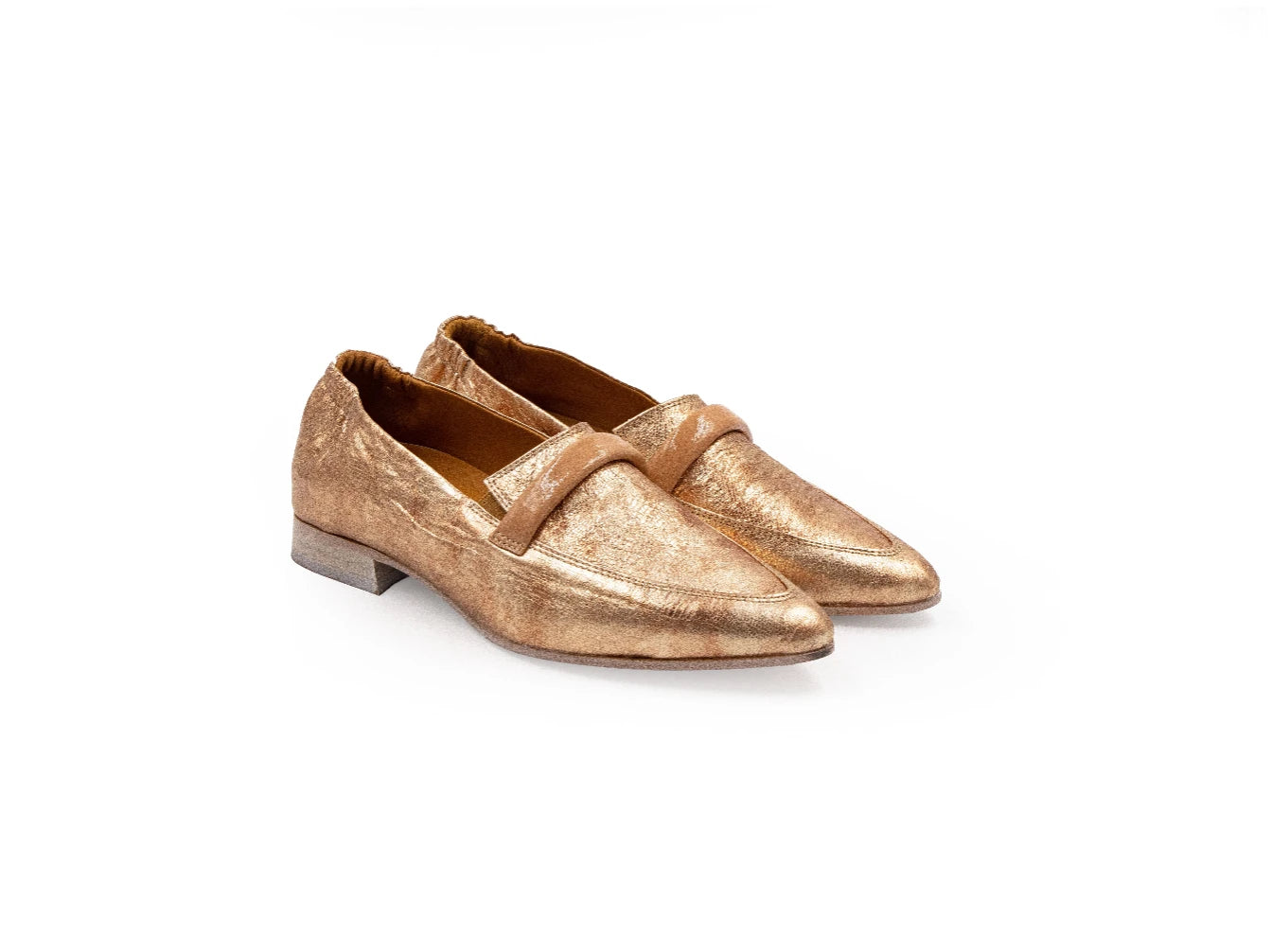 Pair of gold loafers on a white background
