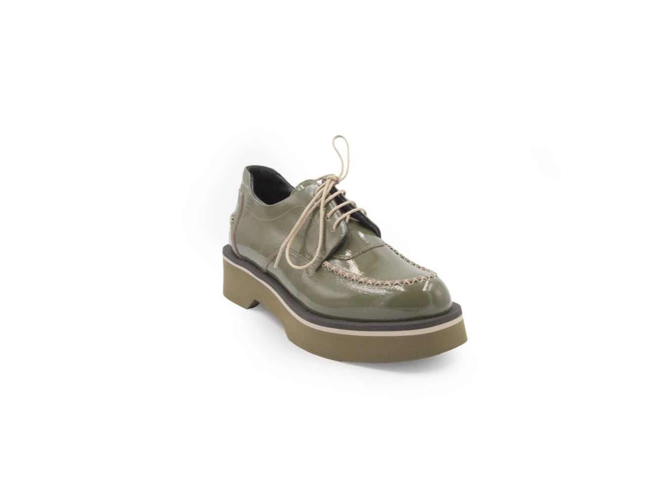 Green leather shoe with a thick sole on a white background