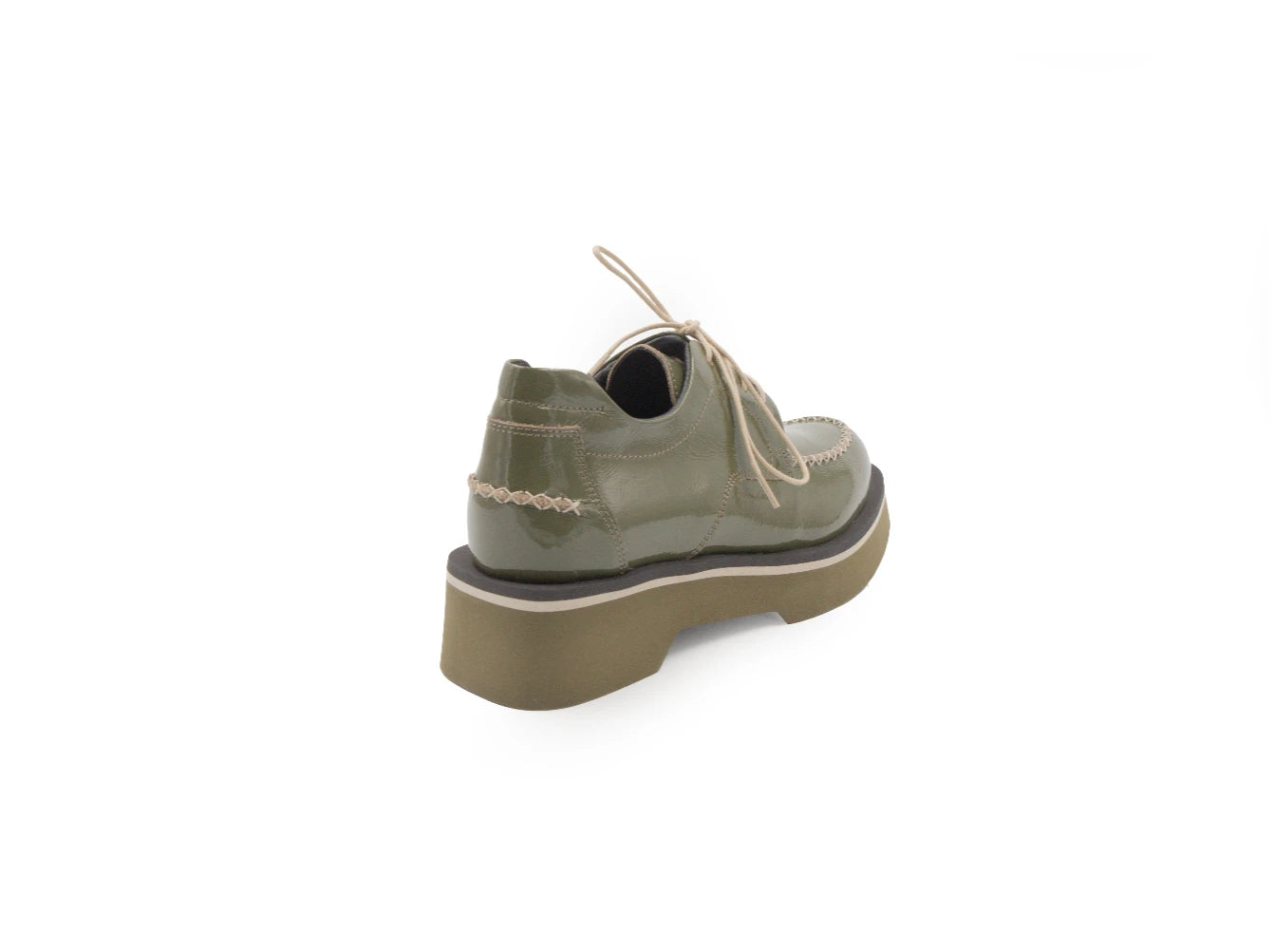 Green leather shoe with a thick sole on a white background