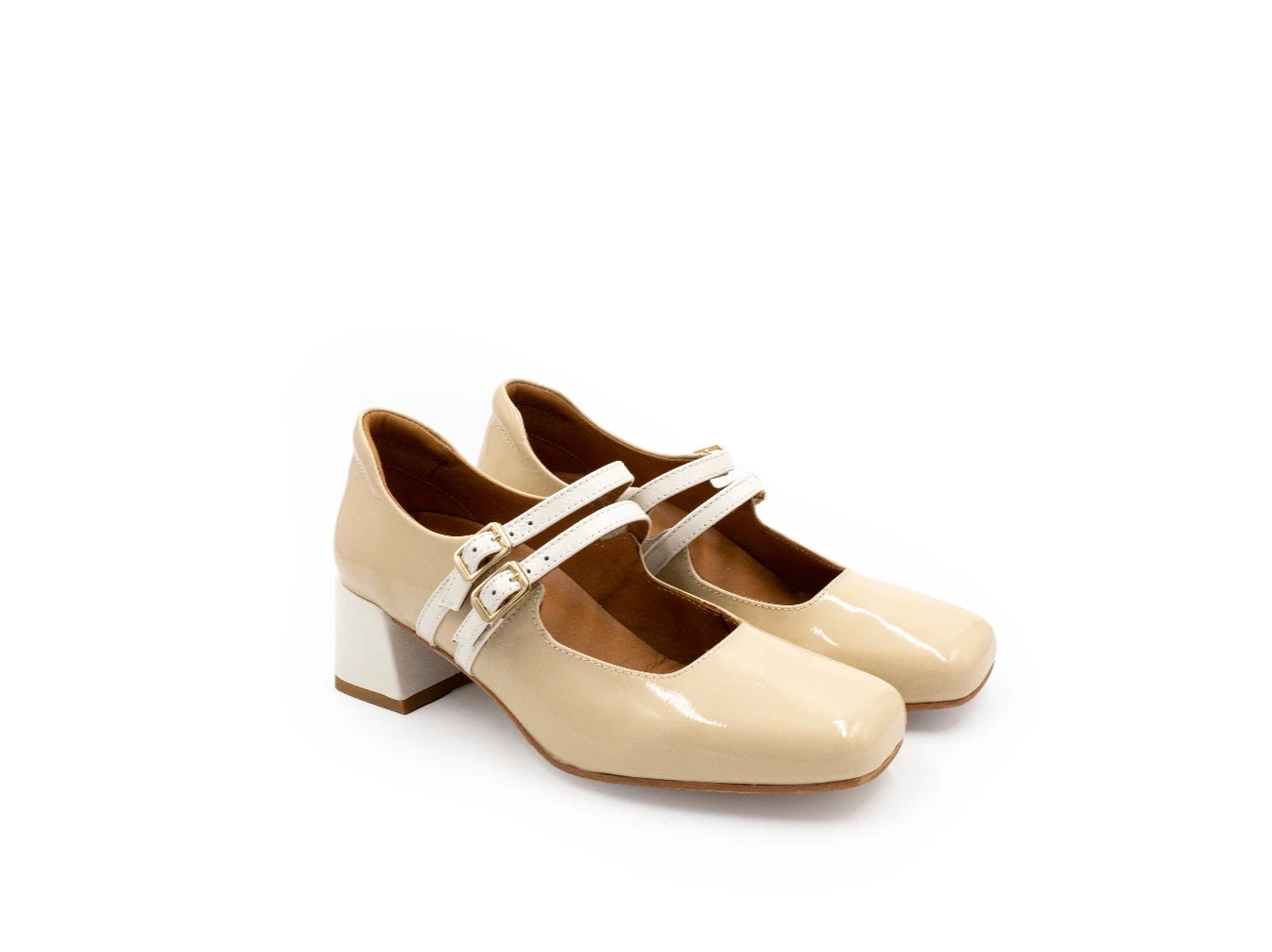 Pair of beige shoes with white straps on a white background