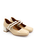 Pair of beige shoes with white straps on a white background